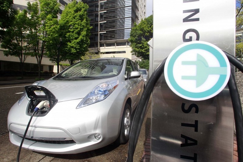 A Nissan Leaf charging in Portland, OR. CREDIT: AP / RICK BOWMER