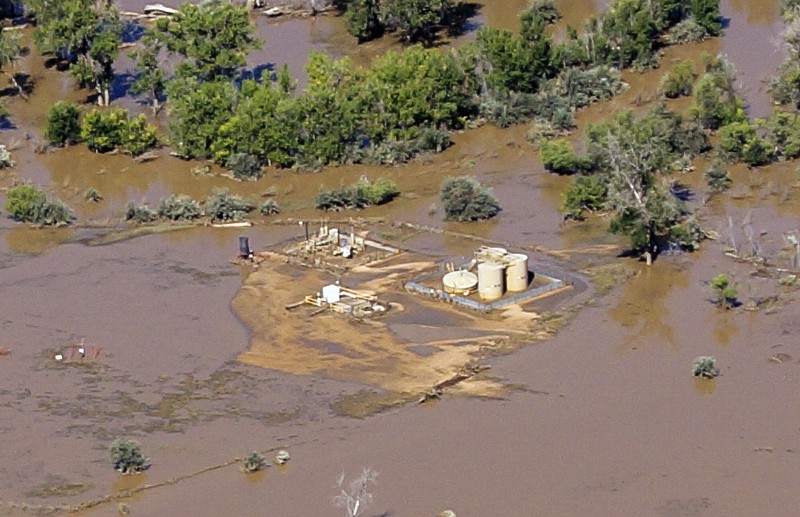 Flood waters swamped well pads and in some cases dislodged storage tanks in Weld County. CREDIT: AP PHOTO/ECOFLIGHT, JANE PARGITER