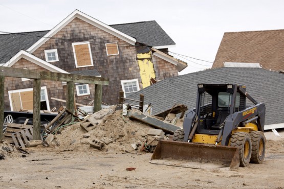 A bulldozer in front of destroyed homes on January 13, 2013 in Lavallette, New Jersey. Clean up continues 75 days after Hurricane Sandy struck the shore in October 2012. CREDIT: Glynnis Jones