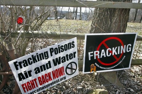 Signs opposing the hydraulic fracturing process of drilling for gas, or “fracking”, are posted in the front of the yard of Janet McIntyre ‘s Evans City, Pa. home on Thursday, Feb. 23, 2012. CREDIT: AP PHOTO/KEITH SRAKOCIC