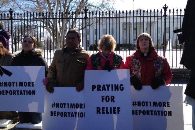 Rev. Dr. Sharon Stanley- Rea (second from right) and other immigration advocates kneel on towels in front of the White House to pray for the President to stop deportations. CREDIT: ThinkProgress/ Esther Y. Lee