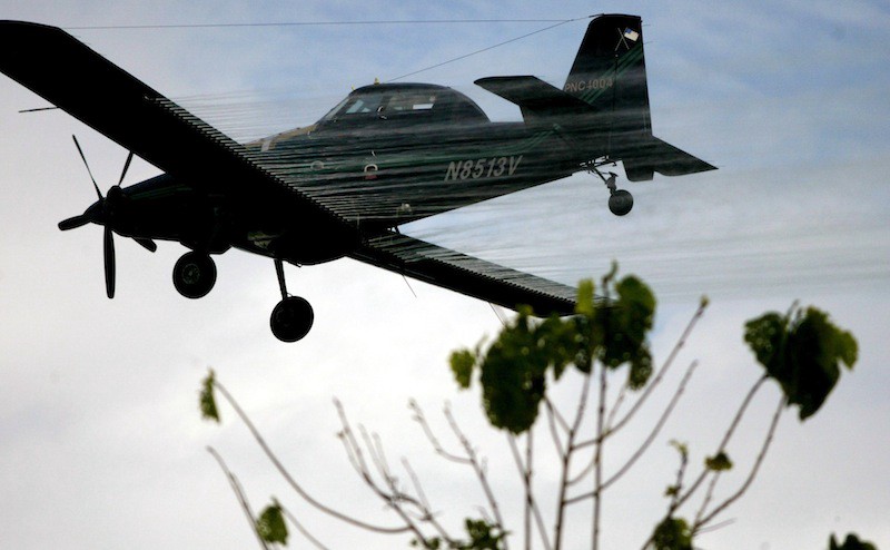 A plane sprays coca fields in San Miguel, on Colombia’s southern border with Ecuador, Friday, Dec. 15, 2006. CREDIT: WILLIAM FERNANDO MARTINEZ/ASSOCIATED PRESS