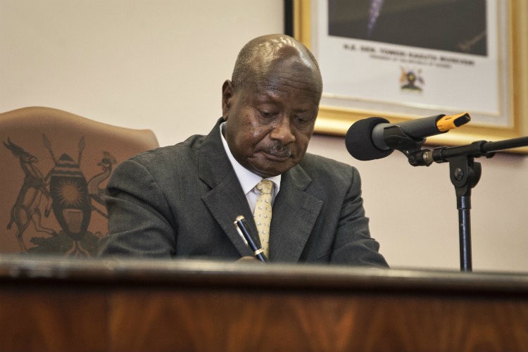 Uganda’s President Yoweri Museveni signing the anti-homosexuality bill into law. CREDIT: AP PHOTO/REBECCA VASSIE