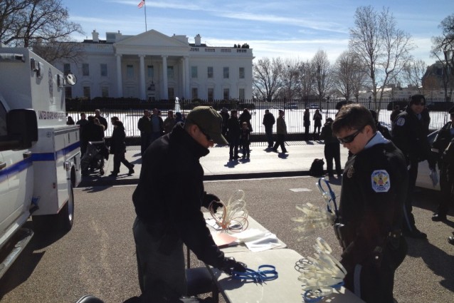 Police prepare plastic handcuffs to use on faith leaders and undocumented protesters. CREDIT: ThinkProgress/ Esther Y. Lee
