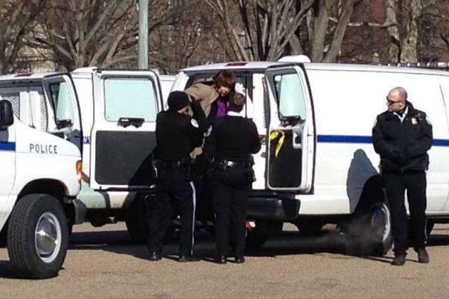 Bishop Minerva Carcano was arrested and put in a police van. CREDIT: ThinkProgress/ Esther Y. Lee