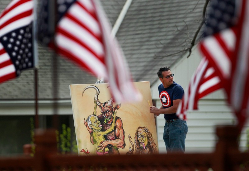 New York City artist Scott LoBaido works on his painting of Rev. Fred Phelps and daughter outside Westboro Baptist Church in Topeka, Kan., Sunday, April 17, 2011. CREDIT: AP PHOTO/ORLIN WAGNER