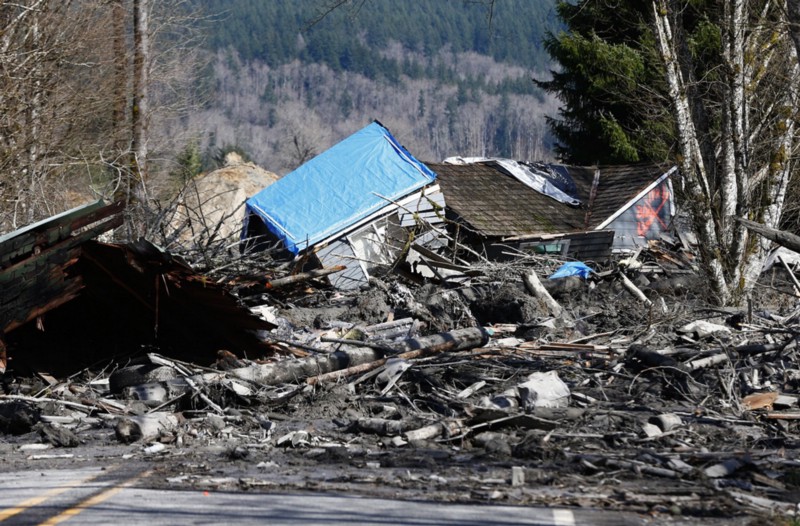 A house is seen destroyed in the mud on Highway 530 next to mile marker 37 on Sunday, March 23, 2014, the day after a giant landslide occurred. CREDIT: AP/LINDSEY WASSON