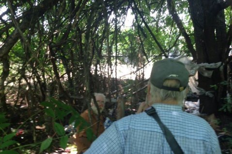 Jim Kinnamon’s group approaching a homeless man living in the woods last year CREDIT: Jim Kinnamon’s Facebook page