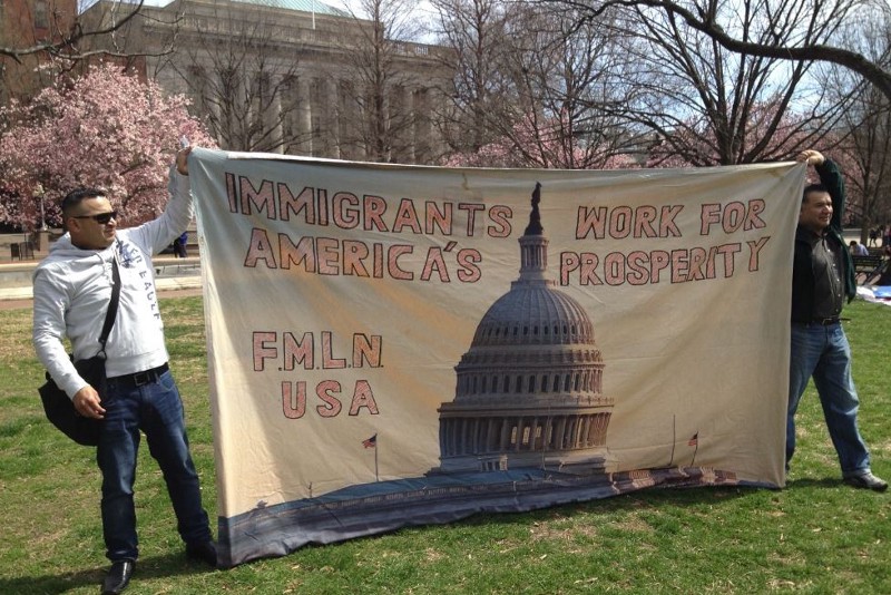 Two men hold a banner at the April 5th rally in a park near the White House, that reads “Immigrants work for America’s prosperity.” CREDIT: THINKPROGRESS/ ESTHER Y. LEE