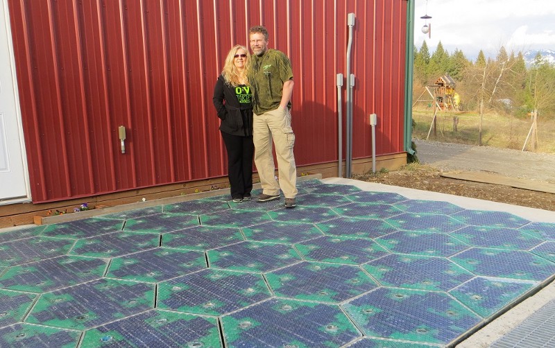 Scott and Julie Bradshaw stand on a prototype for a Solar Roadway parking lot. The prototype is largely finished, aside from mounting holes, mastic between panels, and software for LED patterns that still need to be added.