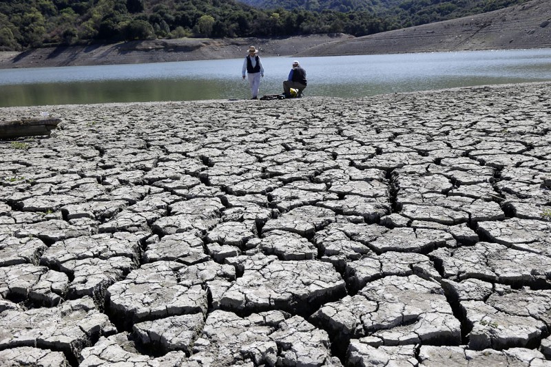 The dry bed of the Stevens Creek Reservoir is seen in March in Cupertino, Calif. CREDIT: AP PHOTO/MARCIO JOSE SANCHEZ