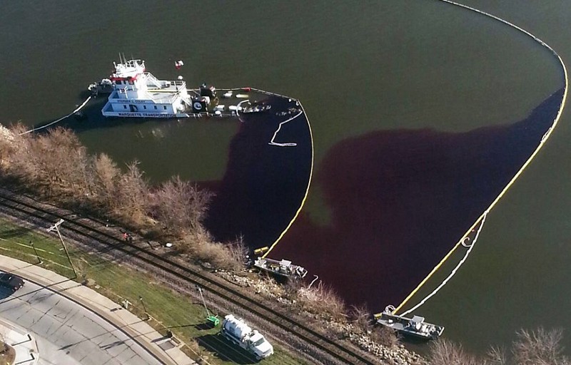This aerial photo provided by the U.S. Fish and Wildlife Service shows a partially sunken towboat that spilled oil into the Mississippi River in LeClaire, Iowa, Wednesday, Nov. 27, 2013. CREDIT: AP PHOTO/U.S. FISH AND WILDLIFE SERVICE