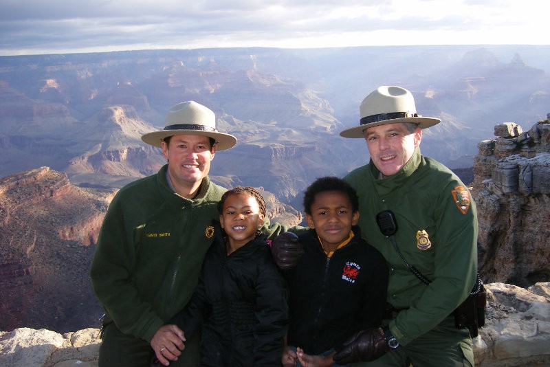 David Smith and John Evans pose at the Grand Canyon, where they were once worked, with their children Jakiah and Dante. CREDIT: DAVID SMITH.