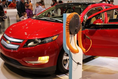 A Chevrolet Volt model 2011. The orange charging cord plugs into a standard 3-prong, 120-volt socket. CREDIT: Shutterstock