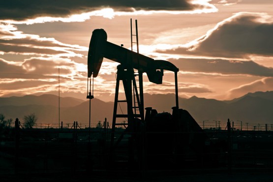 In this Dec. 5, 2012 photo, the sun sets behind an oil pump jack and the Rocky Mountains near Fredrick, Colo. CREDIT: AP Photo/Ed Andrieski