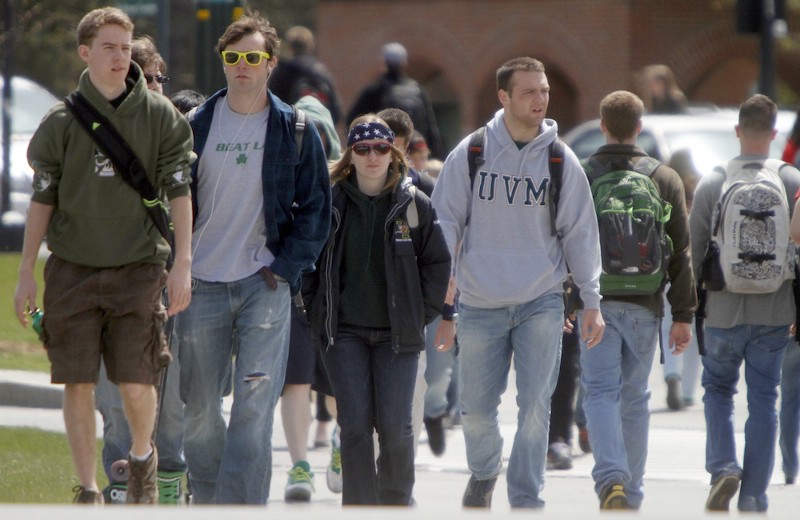 Students walking across campus at the University of Vermont. CREDIT: AP