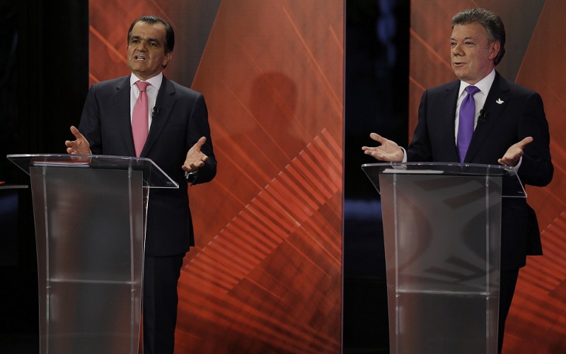 President Juan Manuel Santos, right, and his opponent, Oscar Ivan Zuluaga CREDIT: AP PHOTO/FERNANDO VERGARA