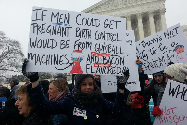 Protesters hold signs in support of Obamacare’s birth control mandate CREDIT: THINKPROGRESS/SY MUKHERJEE