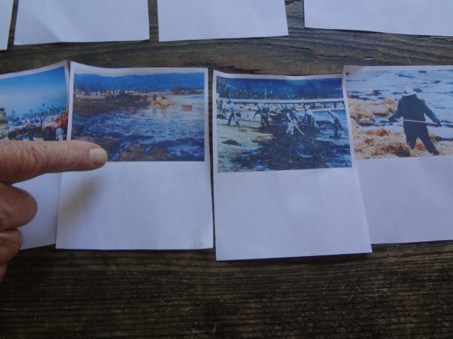 Bud Bottoms points to photos he took of the 1969 Santa Barbara oil spill cleanup effort. CREDIT: Ari Phillips