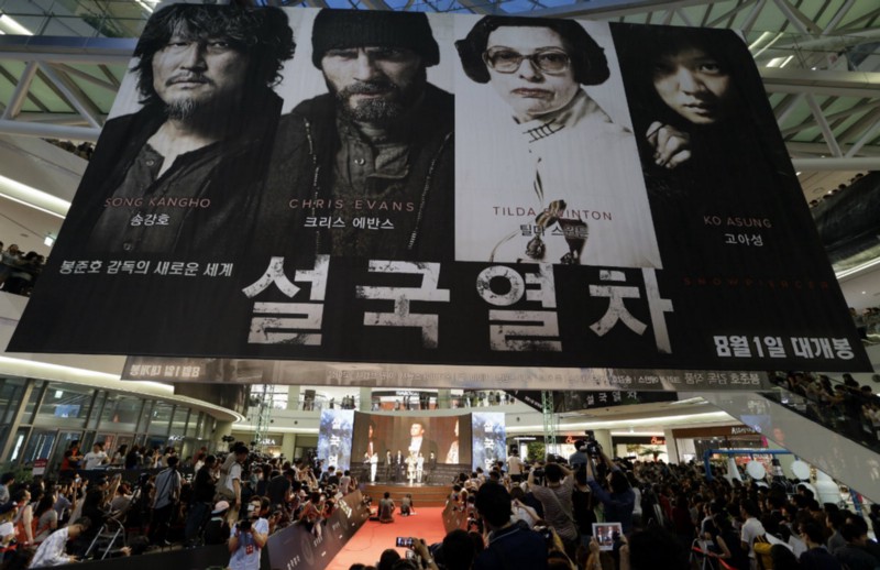 A banner of the film “Snowpiercer” hangs during its world premiere in Seoul, South Korea. CREDIT: AP PHOTO/LEE JIN-MAN