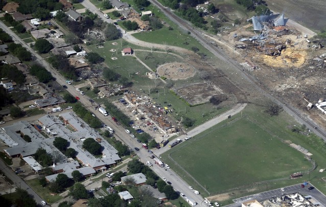 In this April 18, 2013 photo are the remains of a nursing home, left, apartment complex, center, and fertilizer plant, right, destroyed by an explosion in West, Texas. The families of 15 people that died in the plant explosion, 12 of them trying to respond to the initial fire, have spent the last year navigating the difficult balance between seeking answers and finding closure. CREDIT: AP/Tony Gutierrez