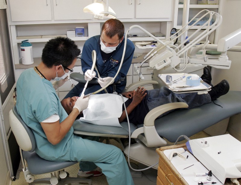 A student receives treatment in the mobile dental group Help A Child Smile at Peek’s Chapel Elementary School in Conyers, Ga. CREDIT: AP PHOTO/GENE BLYTHE