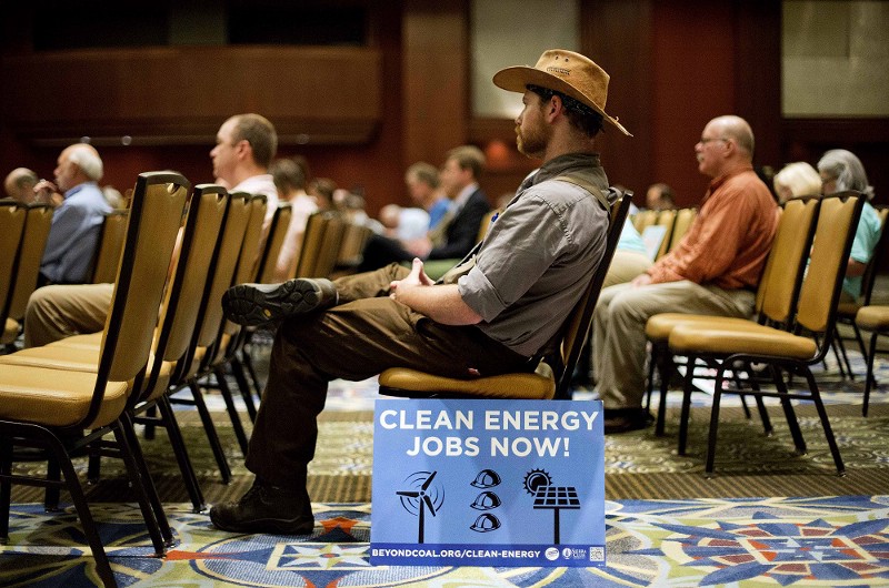 A man sits at an EPA hearing on the Clean Power plan in Atlanta Tuesday. CREDIT: AP PHOTO/DAVID GOLDMAN