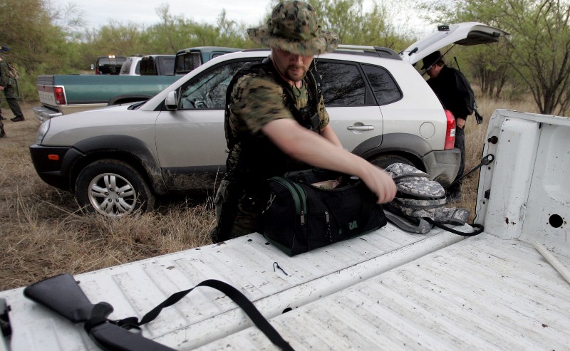 A militiaman staged at a Texas ranch in 2006 CREDIT: AP PHOTO/ERIC GAY)