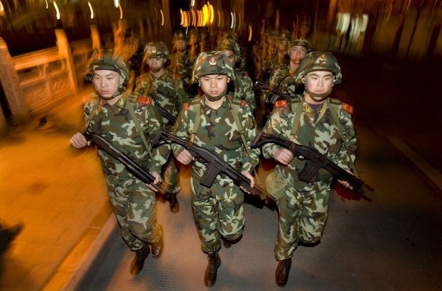 Chinese People’s Armed Police officers march on the streets of Kangding, Ganzi prefecture of southwestern China’s Sichuan province CREDIT: AP Photo/Ng Han Guan, File