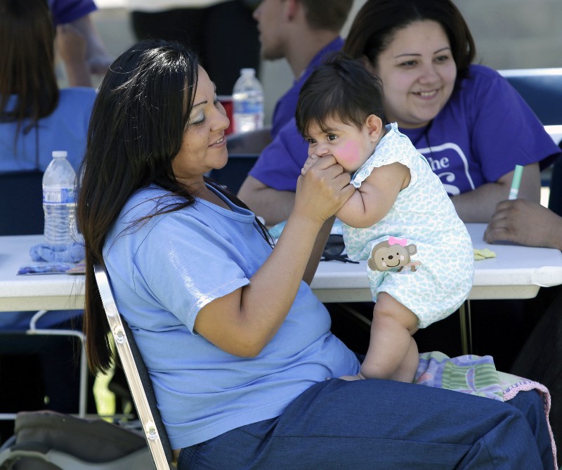 In this photo taken May 3, 2014, inmate Serina Diaz spends time with her granddaughter, Elena Montes, 7 months, during a visit at the Folsom Women’s Facility in Folsom Calif. CREDIT: AP PHOTO/RICH PEDRONCELLI