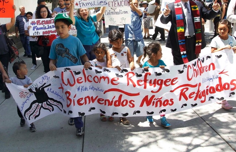 Immigrant families and children’s advocates rally in response to President Barack Obama’s statement on the crisis of unaccompanied children and families illegally entering the United States, outside the Los Angeles Federal building in July. CREDIT: NICK UT/ AP