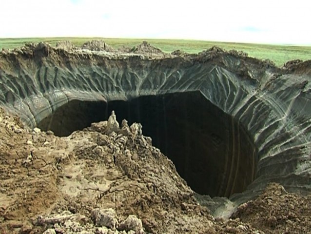 This frame grab made Wednesday, July 16 shows the 200-foot wide crater discovered in the Yamal Peninsula. CREDIT: Associated Press Television