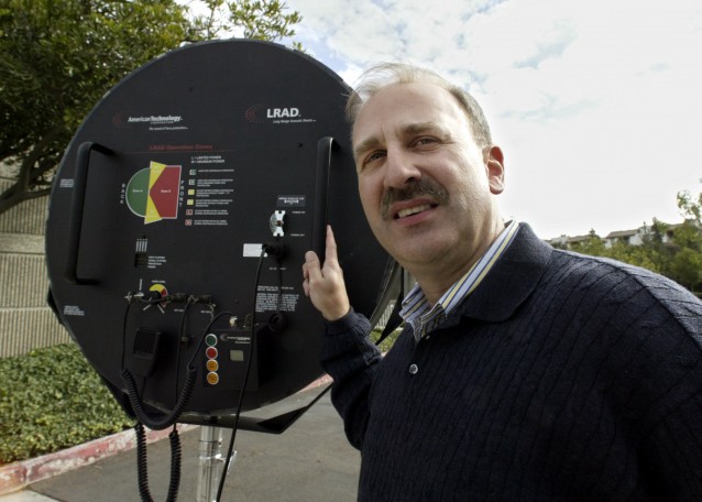 Carl Gruenler, vice president of military and government operations for LRAD Corporation, displays a Long Range Acoustic Device CREDIT: AP PHoto/Lenny Ignelzi