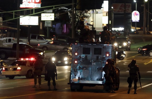 Police attempt to secure a street after a clash with protesters Wednesday. CREDIT: AP Photo/Jeff Roberson