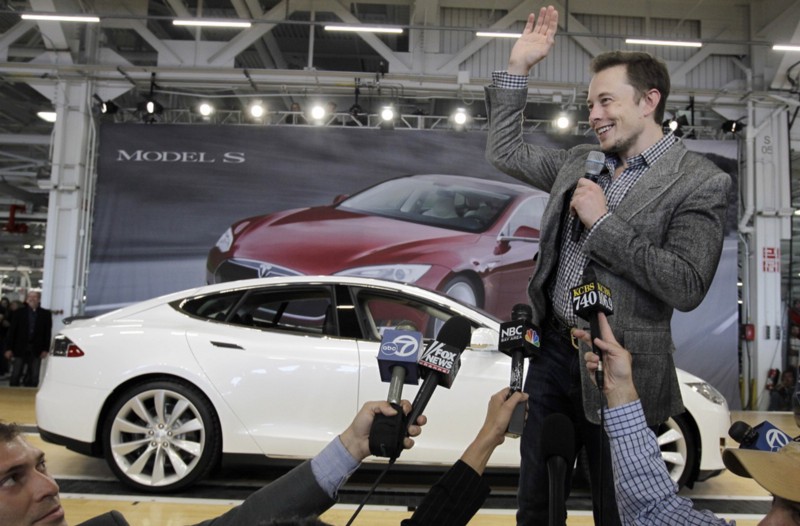 In this June 22, 2012 file photo, Tesla CEO Elon Musk waves during a rally at the Tesla factory in Fremont, Calif. Tesla Motors has selected Nevada for a massive, $5 billion factory that it will build to pump out batteries for a new generation of electric cars, a person familiar with the company’s plans said Wednesday, Sept. 3, 2014. CREDIT: AP/PAUL SAKUMA