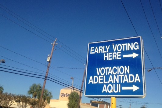 A sign points to an early voting location in Houston, Texas. CREDIT: EMILY ATKIN