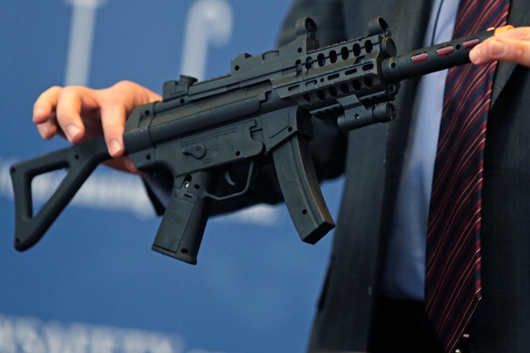 James Swartz of World Against Toys Causing Harm displays a toy gun on sale for the holidays this year. CREDIT: AP PHOTO/CHARLES KRUPA