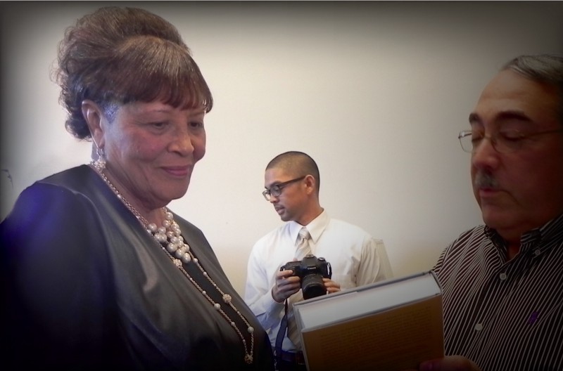 Rep. Elect Alma Adams receives a welcoming gift from fellow North Carolina Rep. George Kenneth Butterfield. CREDIT: ALICE OLLSTEIN