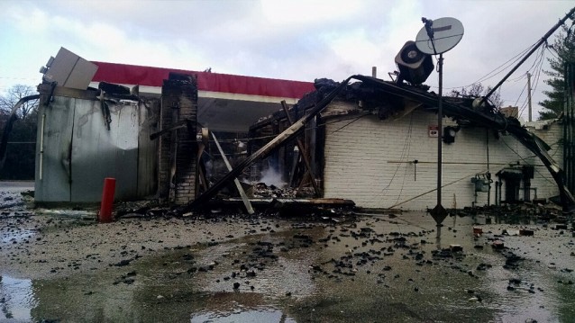 A woman tells ThinkProgress that gas continues to leak from this burned-down gas station CREDIT: ThinkProgress/ Carimah Townes/ Erica Hellerstein