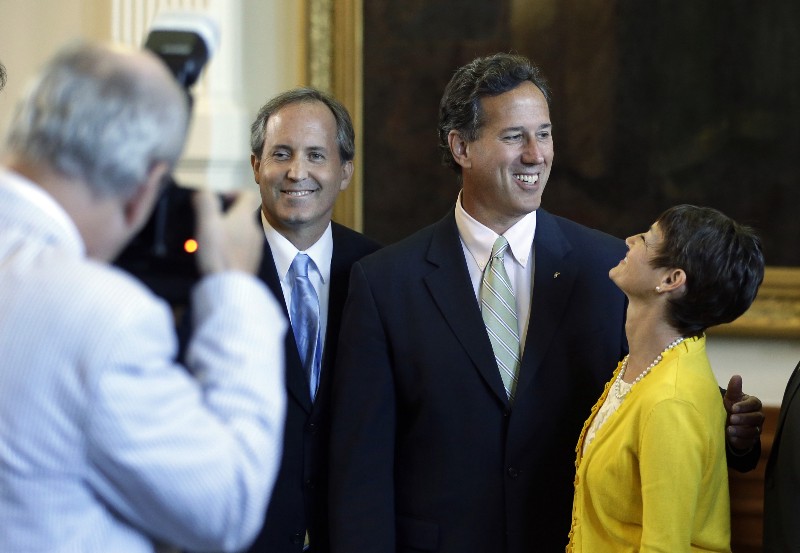 State Sen. Donna Campbell (R), seen here looking up at Rick Santorum in 2013, is proposing a constitutional amendment protecting a religious right to discriminate against LGBT people. CREDIT: AP
