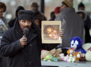 Activist Art McCoy holds a photo of Tamir Rice before a protest. CREDIT: AP Photo/Mark Duncan