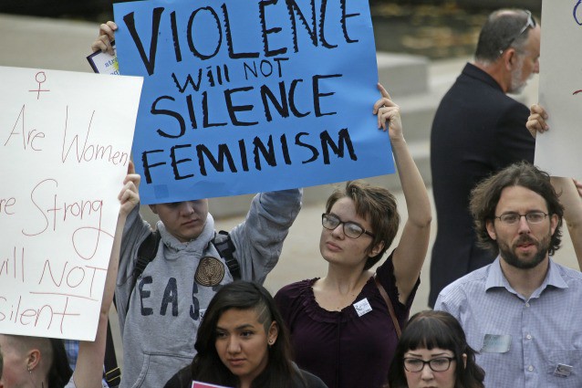 People protest on the campus of Utah State, Wednesday, Oct. 15, 2014, in Logan, Utah. Utah’s campus gun laws are in the spotlight after Anita Sarkeesian canceled a speech at Utah State University once she learned the school would allow concealed firearms despite an anonymous threat against her. (AP caption) CREDIT: AP Photo/Rick Bowmer