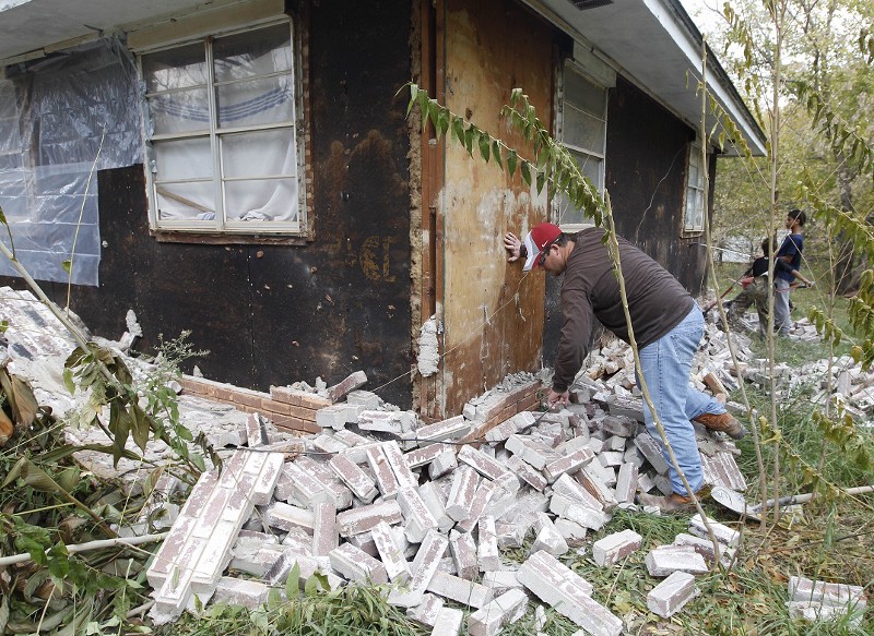 In this Nov, 6, 2011 photo, Chad Devereaux examines bricks that fell from three sides of his in-laws home in Sparks, Okla., following two earthquakes that hit the area in less than 24 hours. CREDIT: AP PHOTO/SUE OGROCKI