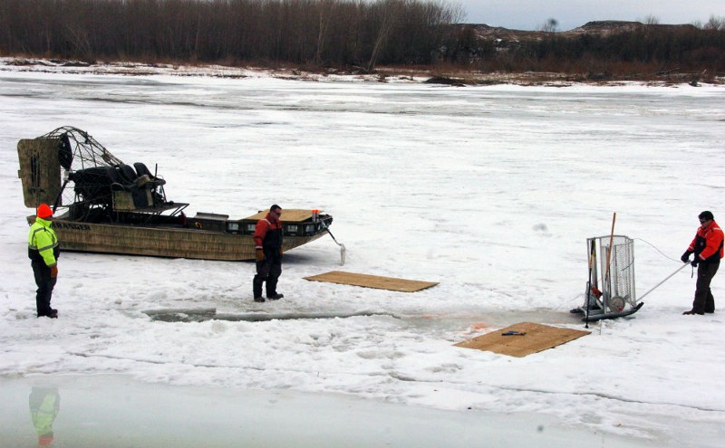 Cleanup workers cut holes into the ice on the Yellowstone River near Crane, Mont. on Monday, Jan. 19, 2015 as part of efforts to recover oil from an upstream pipeline spill that released up to 50,000 gallons of crude. CREDIT: AP PHOTO/MATTHEW BROWN