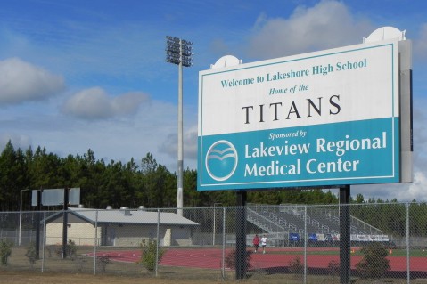 The entrance to Lakeshore High School sits just 1,500 feet from the wooded wetland site Helis has leased for a fracking well. CREDIT: Alice Ollstein
