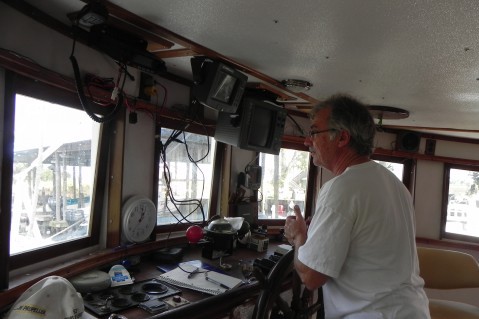 Commercial shrimper George Barisich steers his boat to the refueling dock. CREDIT: Alice Ollstein