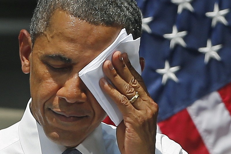 In this June 25, 2013, file photo President Barack Obama wipes perspiration from his brow during an ambitious speech about climate change under a steaming hot sun at Georgetown University in Washington. CREDIT: AP PHOTO/CHARLES DHARAPAK, FILE
