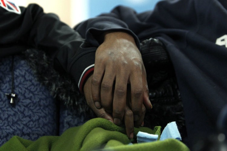 Two boys hold hands at the Ruth Ellis Center, a drop-in shelter for LGBT youth in Detroit. CREDIT: AP PHOTO/PAUL SANCYA