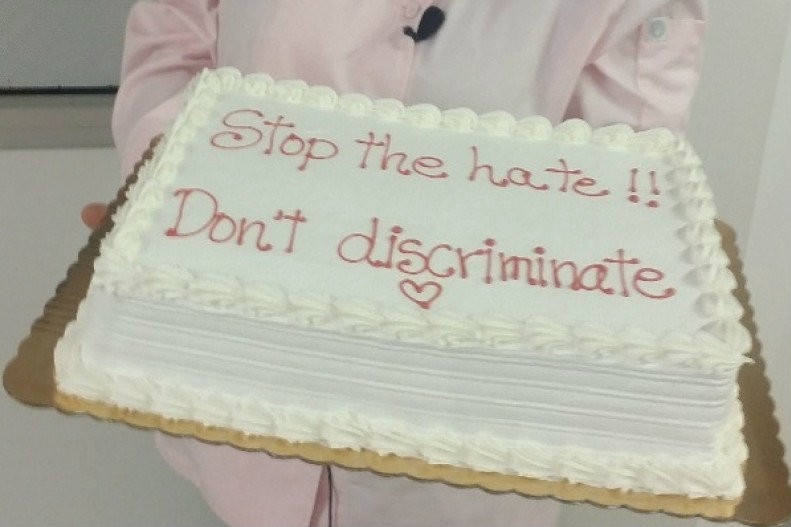 Marjorie Silva holds a cake with a message she supports. CREDIT: FACEBOOK/AZUCAR BAKERY