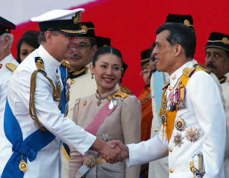 British Prince Andrew, left, shakes hands with Thailand’s Crown Prince Maha Vajiralongkorn, right, as his royal consort Princess Srirasm in Aug. 2007. CREDIT: AP